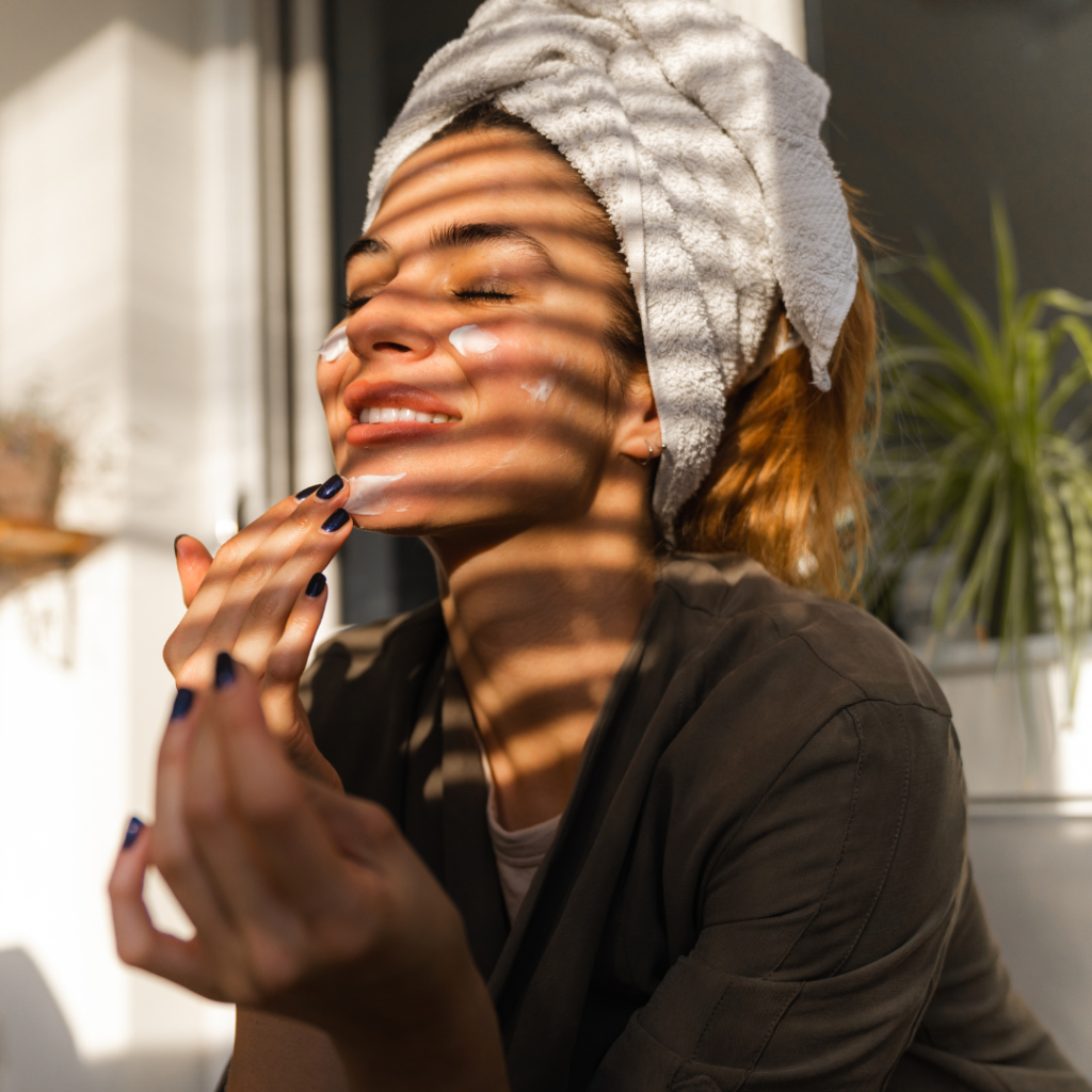 a woman applying a facemask
