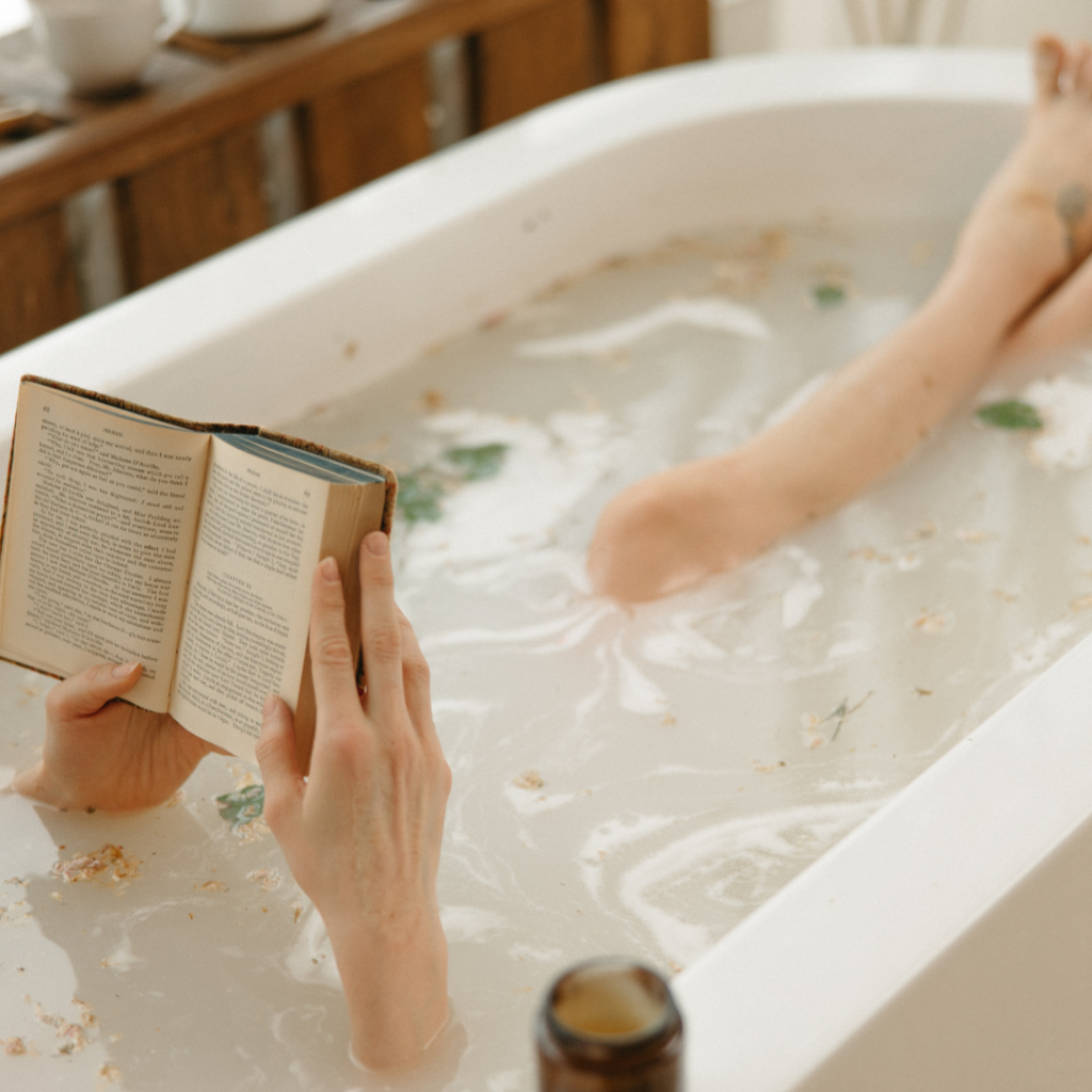 A woman reading a book in the bathtub
